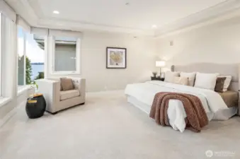 Generous primary bedroom with crown molding detail. Enjoy lake views as your start and end your day.