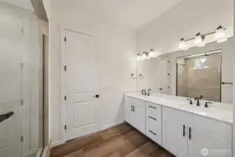 This home has a different color cabinet that is called Artic Grey stain - with a color palate of light grey flooring a grey tile. NOT ACTUAL HOME but represents the layout.