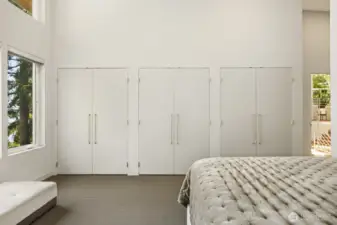 Primary with full wall of closets + walk in closet
