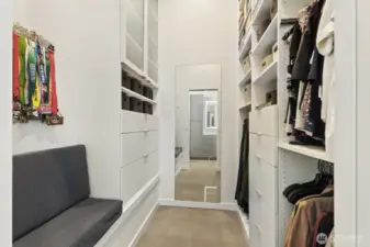 Walk-in closet with floor to  ceiling storage.