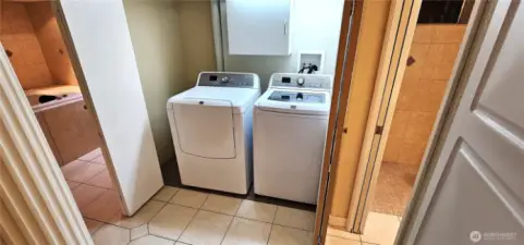 Laundry area behind folding doors.