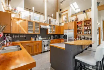 Dramatic Vaulted ceilings with soaring glue lam beams. The counters are "Superyacht" quality hardwoods and intended to provide a Nautical vibe.