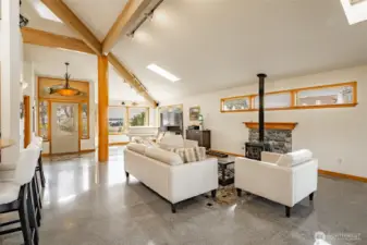 Gas free standing fireplace against a stone hearth provides comforting warmth when the Winter Inland Pacific seasons arrive.