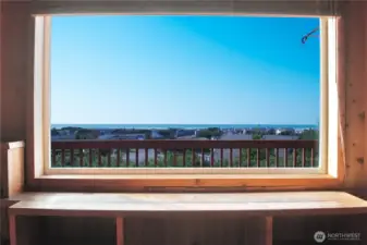 The upstairs living room showcases a stunning picture-frame ocean view that brings the coastline right into the home.