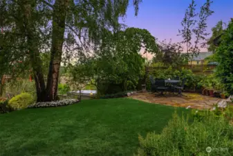 The perfect combination of grass, patio and herbaceous borders.