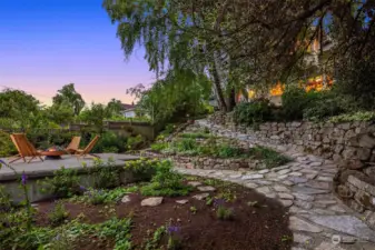 The hillside was re-designed with natural handpicked rockery acting as retaining walls, flower beds and meandering stone path.