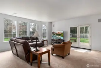 Large family room with french doors leading out to the deck & patio area overlooking the expansive private backyard!