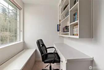 Bedroom #3 built-in desk area with shelves & window seat.