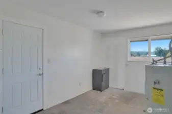 Laundry room with car port and kitchen entrance