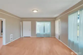 Looking at the living room with entrance to the primary bedroom on the left