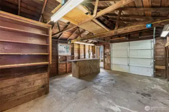 The detached garage includes a built-in bar area that adds a fun and functional touch to the space. Whether you’re entertaining friends, setting up a workshop refreshment station, or using it as a practical workbench area, this versatile feature enhances the garage’s charm and usability.