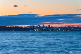 Enjoy serene west-facing views that stretch beyond the tip of Mercer Island to the glittering Seattle skyline, where tranquil waters meet the vibrant city lights.