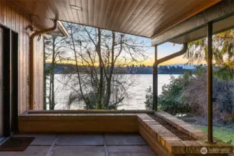 Just imagine—every time you come home, this is the view that welcomes you before you even reach the front door. A covered approach that doubles as a perfect place to linger and take in the lake