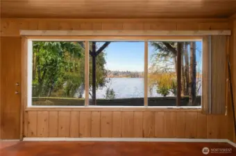 Expansive picture windows frame stunning lake views, creating a seamless connection between the indoors and the natural waterfront setting.