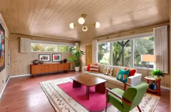 Virtually staged lower-level living area styled in keeping with the home’s mid-century era.