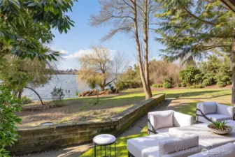 Lower-level patio with tranquil views across the lawn to the water’s edge.
