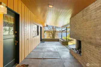A covered approach from the carport to the front door sets the stage for a grand arrival—framing Lake Washington views the moment you step onto the property.