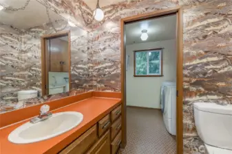 Half bath and laundry room with utility sink