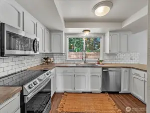 White cabinets and white tile backsplash
