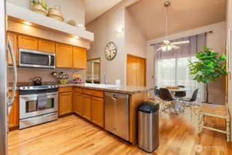 Large kitchen with granite counters, SS appliances and a sky light.