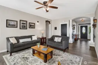 This open-concept living room offers both comfort and versatility, with generous space to accommodate a variety of furniture configurations.