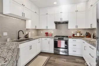 The custom tiled backsplash & under counter lighting add the pizzazz! This IS the kitchen of your dreams!