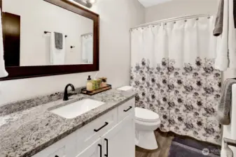 The main bath features a tub/shower combination and updated vanity with Nevaska slab granite as well.