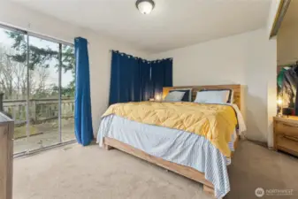 The main-level primary bedroom offers comfort and convenience, complete with direct access to the upper deck—perfect for enjoying morning coffee or evening sunsets.