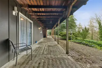 The lower-level patio offers an outdoor retreat, ideal for relaxing, entertaining, or enjoying the surrounding greenery and fresh air.