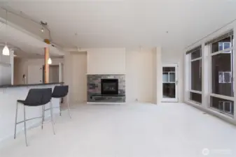 Living room with gas fireplace and wall of windows