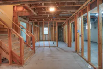 Basement landing with former 4th bedroom straight ahead. Flex space and laundry area to the right
