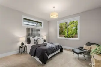 Main level 5th bedroom suite with walk in closet overlooking the backyard.