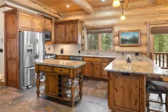 Stainless appliances, granite countertops and large bar provides extra seating.