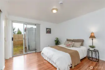 Primary bedroom with access to the fenced in yard.