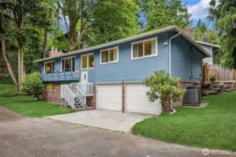 Inviting front entry with mature landscaping and curb appeal