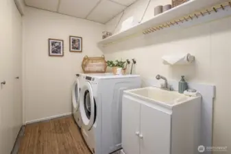 Large well-equipped laundry room with with wash sink and...more storage