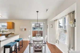 Dining area has plenty of space and leads to the backyard