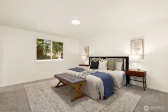 Large primary suite overlooks backyard.