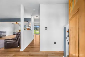 Entry to home. Open concept with wood laminate floors and updated lighting. Lots of windows for extra natural light.