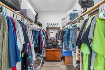 Primary closet downstairs with barndoor entrance. Step down into closet with plenty of room available.