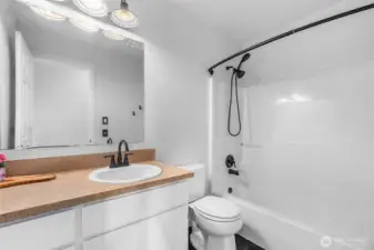 Hall bathroom upstairs with shower and tub. Updated fixtures and lighting.