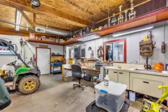 This is a view of the office area with built in desk. Has full sink/wash area. Small bathroom behind.