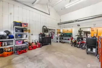 The shop- 200 amp main service. One 100 amp sub panel. Two 50 amp sub panels. Six 30 amp 220 plugs.12 foot eaves. Six inch concrete. Anchor points in slab. Six roll up doors. Four man doors. Ben pak 10,000 pound car/truck hoist.4 ton HVAC unit with spiral ductwork. Bathroom. Utility sink. Hot water. Small refrigerator. Office area. Fiber high speed internet. 4 power cord reels. One air hose reel. RV power plug. 110 plugs everywhere. Large attic space with plywood floor and an alarm system!