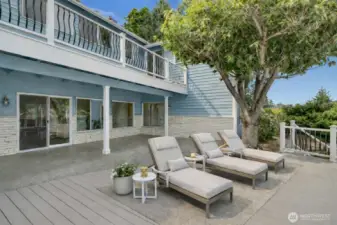 Multiple outdoor living spaces—including a covered patio, Trex deck, and upper deck—bring the bay to you. Virtually staged.