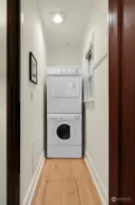 Conveniently located off living room, the Utility room with washer and dryer has a window for ventilation, and dryer provides additional storage space