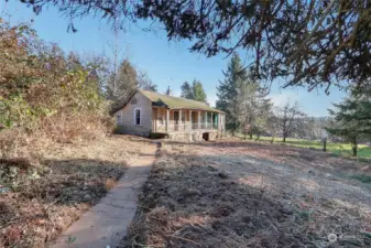 Follow the sidewalk from the driveway to the home