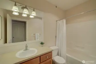 Full bath with a tub/shower combo.