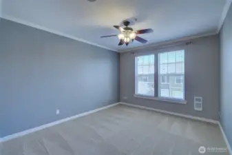 Primary bedroom with a ceiling fan for added comfort.