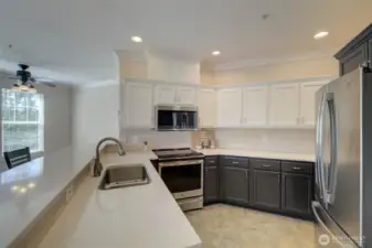 You'll appreciate the ample cabinetry and a peninsula with eating bar.