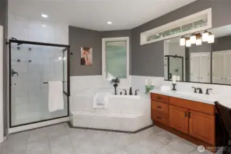 The primary 5-piece bathroom offers dual closets, jetted soaking tub, & dual vanity.